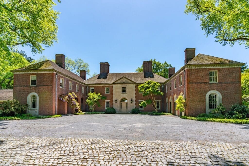 Large brick mansion with symmetrical architecture.